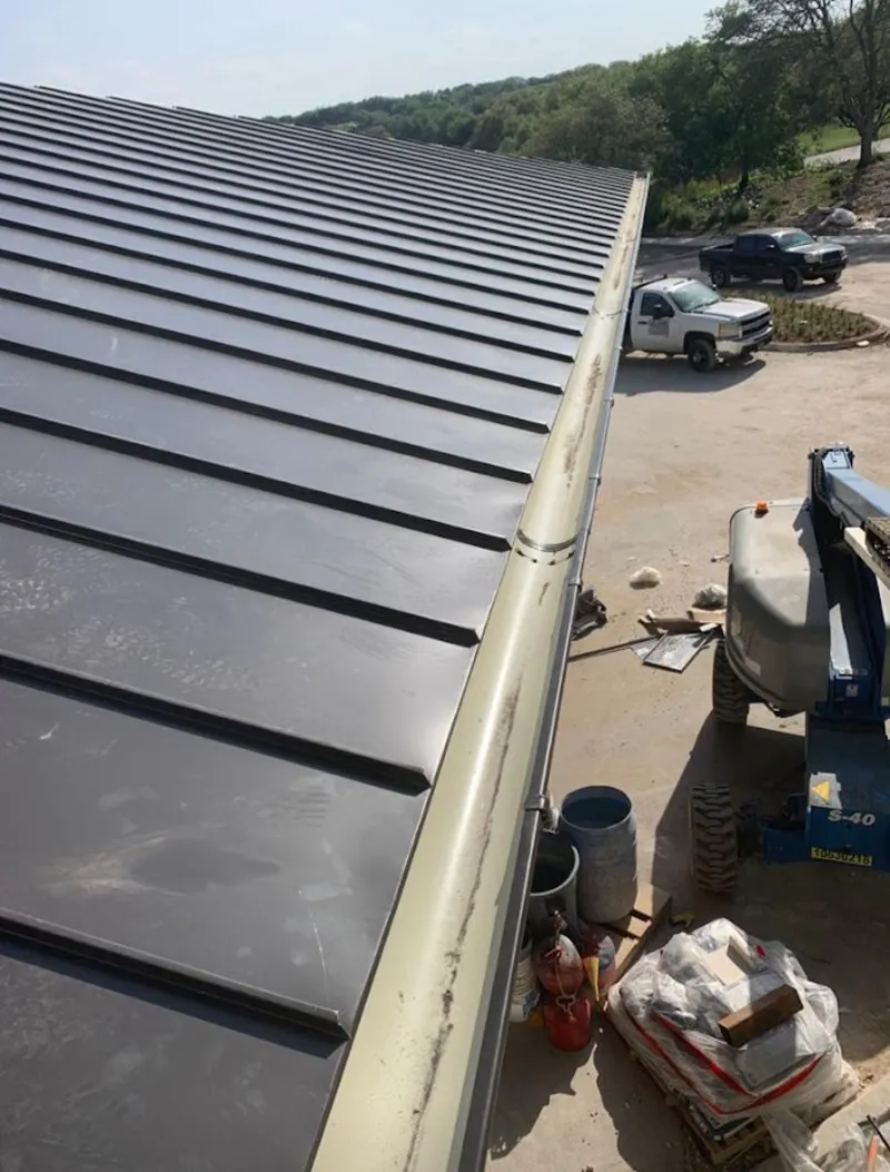 Standing seam panel and gutter detail on a metal roofing jobsite in Shenango